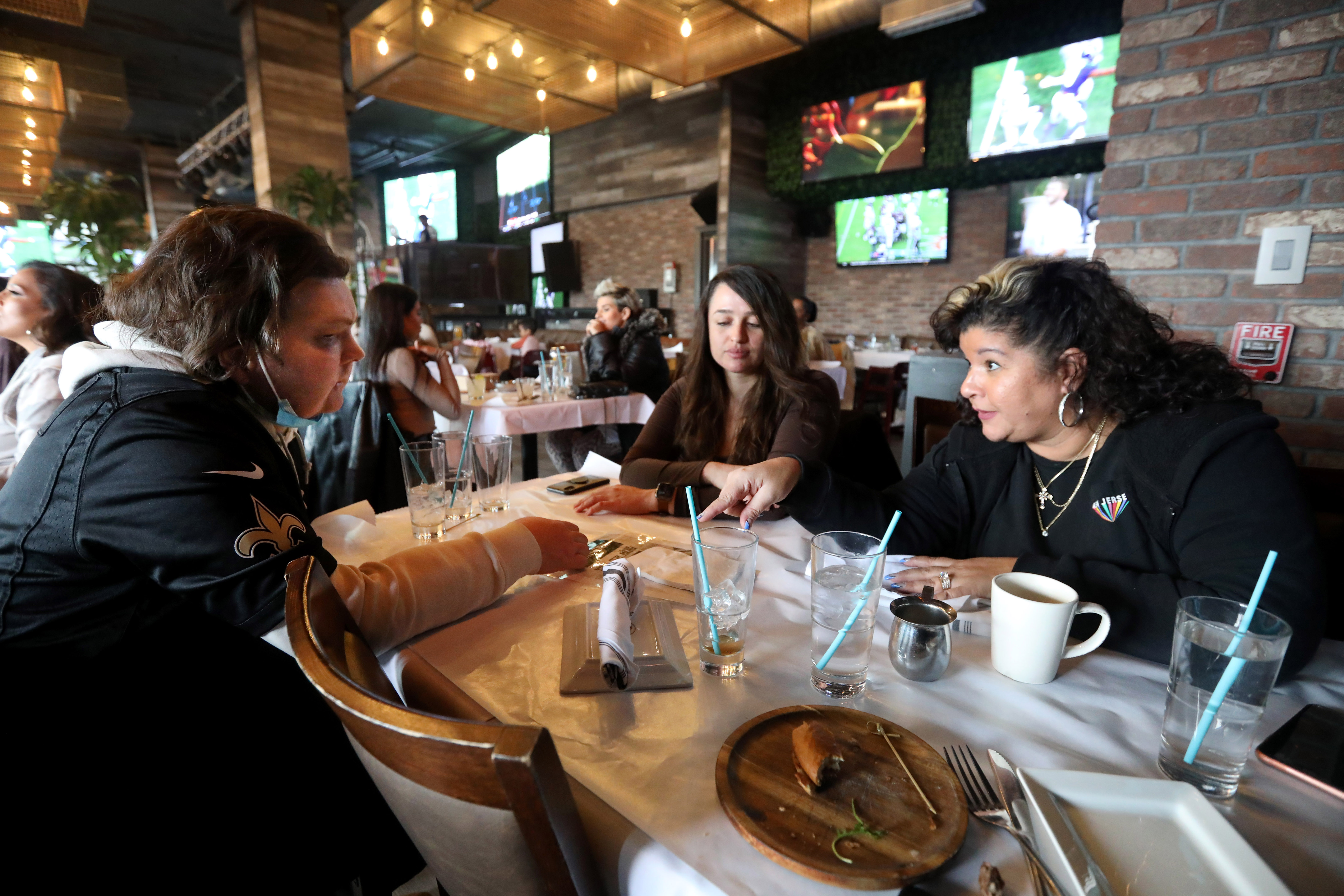 Joe, sitting with his girlfriend, Jessica, and his mother, Rose.